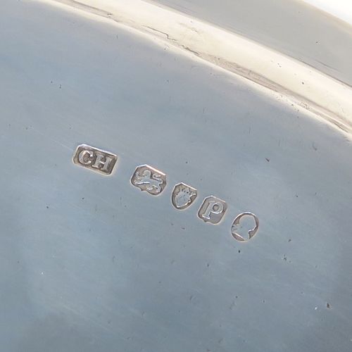 A large and very handsome Antique Georgian Sterling Silver salver, having a round body with an applied reeded border, a plain ground with a hand-engraved full armorial central crest, and sitting on four cast reeded and flanged feet. This elegant antique silver salver was made by Charles Hougham of London in 1790. The dimensions of this fine hand-made antique silver salver are diameter 38 cms (15 inches), and it weighs approx. 1,440g (46.5 troy ounces).