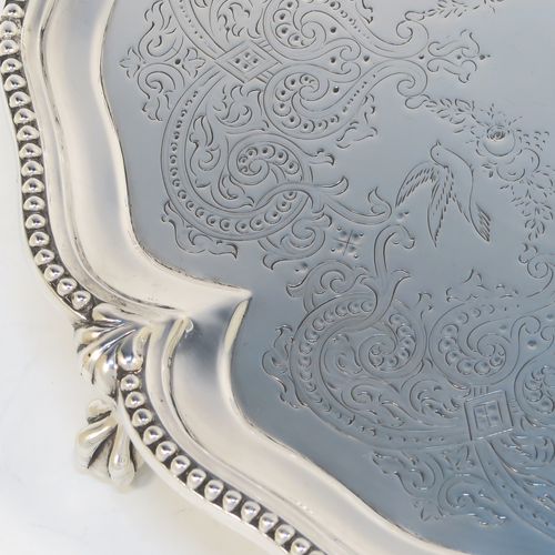 A very pretty Antique Victorian Sterling Silver salver, having an applied and shaped bead-edged border, a hand-engraved ground with floral, scroll, and bird decoration, and sitting on three cast claw and ball feet. This beautiful antique silver salver was made by Stephen Smith of London in 1876. The dimensions of this fine hand-made silver salver are diameter 27.5 cms (10.75 inches), and it weighs approx. 792g (25.5 troy ounces).