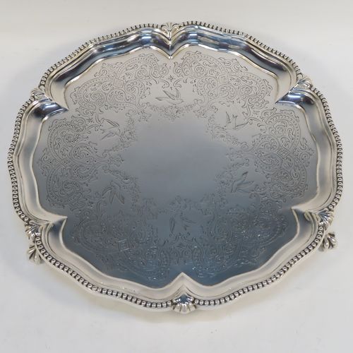 A very pretty Antique Victorian Sterling Silver salver, having an applied and shaped bead-edged border, a hand-engraved ground with floral, scroll, and bird decoration, and sitting on three cast claw and ball feet. This beautiful antique silver salver was made by Stephen Smith of London in 1876. The dimensions of this fine hand-made silver salver are diameter 27.5 cms (10.75 inches), and it weighs approx. 792g (25.5 troy ounces).