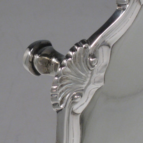 Antique Georgian sterling silver salver, having a shell and scroll border, a plain ground, and sitting on three cast hoof feet. Made by Ebenezer Coker of London in 1768. The dimensions of this fine hand-made silver salver are diameter 29 cms (11.5 inches), and it weighs approx. 688g (22 troy ounces).