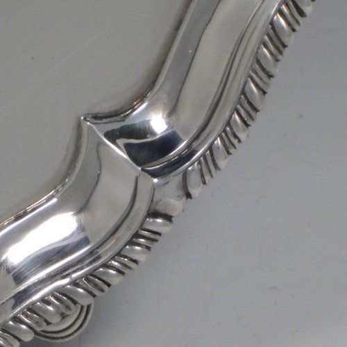 Antique Georgian sterling silver salver, having a shaped gadroon border, a plain ground with a centrally engraved armorial crest, and sitting on three cast hoof feet. Made by Richard Rugg of London in 1770. The dimensions of this fine hand-made silver salver are diameter 30 cms (12 inches), and it weighs approx. 784g (25 troy ounces).