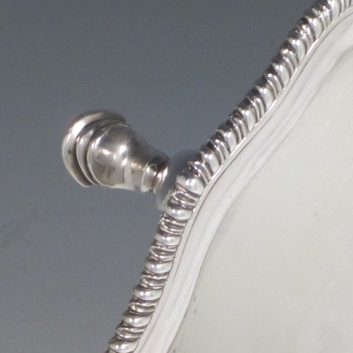 Antique Georgian sterling silver salver, having a shaped gadroon border, a plain ground with a centrally engraved armorial crest, and sitting on three cast hoof feet. Made by Richard Rugg of London in 1770. The dimensions of this fine hand-made silver salver are diameter 30 cms (12 inches), and it weighs approx. 784g (25 troy ounces).