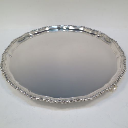 A very handsome Sterling Silver salver, having an applied shaped gadroon border, a plain ground, and sitting on three cast scroll feet. Made by I.S. Greenberg of Birmingham in 1929. The dimensions of this fine hand-made silver salver are diameter 30.5 cms (12 inches), and it weighs approx. 990g (32 troy ounces).