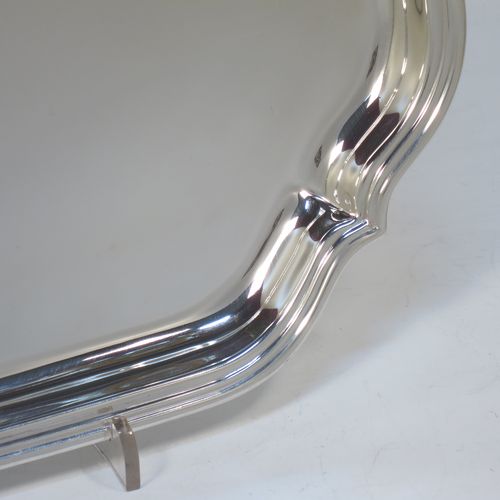 A very handsome Sterling Silver salver, having a square body with shaped and cut corners, a plain burnished ground, an applied reeded border, and sitting on four cast hoof feet. This elegant silver salver was made by Deakin Silversmiths of Sheffield in 1940. The dimensions of this fine hand-made silver salver are 26 cms (10.25 inches) square, and it weighs approx. 625g (20 troy ounces).

   