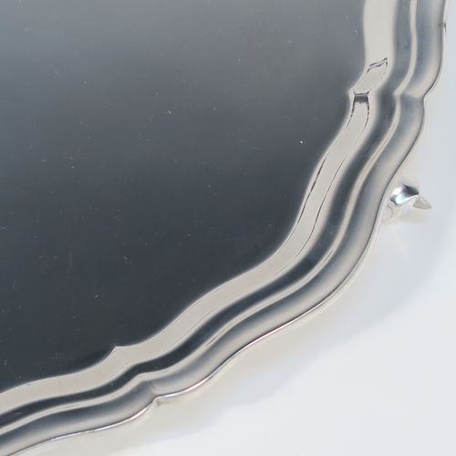 A very elegant Sterling Silver salver, having a round body, with a plain burnished ground, an applied and shaped reeded border, and sitting on three cast scroll feet. This elegant silver salver was made by Emile Viner of Sheffield in 1965. The dimensions of this fine hand-made silver salver are diameter 26 cms (10.25 inches), and it weighs approx. 484g (15.6 troy ounces).