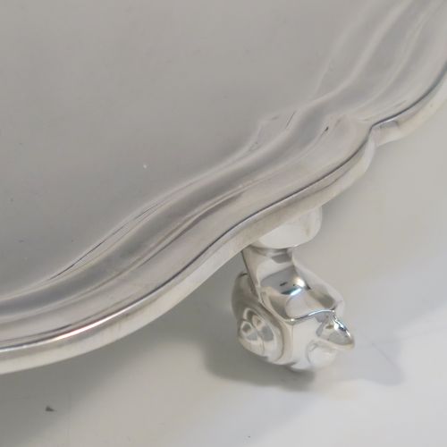 A very elegant Sterling Silver salver, having a round body, with a plain burnished ground, an applied and shaped reeded border, and sitting on three cast scroll feet. This elegant silver salver was made by Emile Viner of Sheffield in 1965. The dimensions of this fine hand-made silver salver are diameter 26 cms (10.25 inches), and it weighs approx. 484g (15.6 troy ounces).