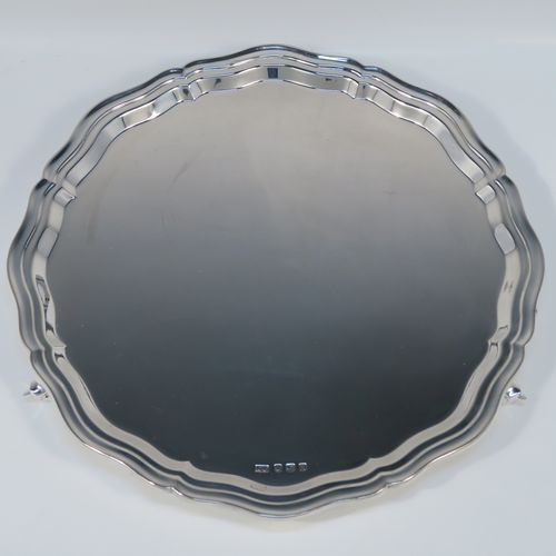 A very elegant Sterling Silver salver, having a round body, with a plain burnished ground, an applied and shaped reeded border, and sitting on three cast scroll feet. This elegant silver salver was made by Emile Viner of Sheffield in 1965. The dimensions of this fine hand-made silver salver are diameter 26 cms (10.25 inches), and it weighs approx. 484g (15.6 troy ounces).