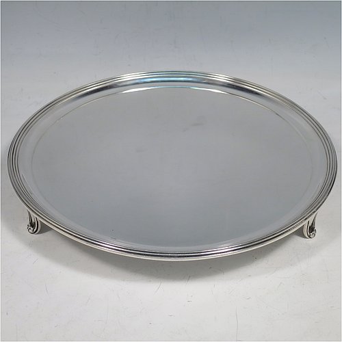 An Antique Georgian Sterling Silver very elegant George III round salver, having a plain ground, an applied reeded border, and sitting on three cast flange feet. Made by Thomas Hannam & John Crouch II of London in 1799. The dimensions of this fine hand-made antique silver salver are diameter 21 cms (8.25 inches), and it weighs approx. 404g (13 troy ounces).