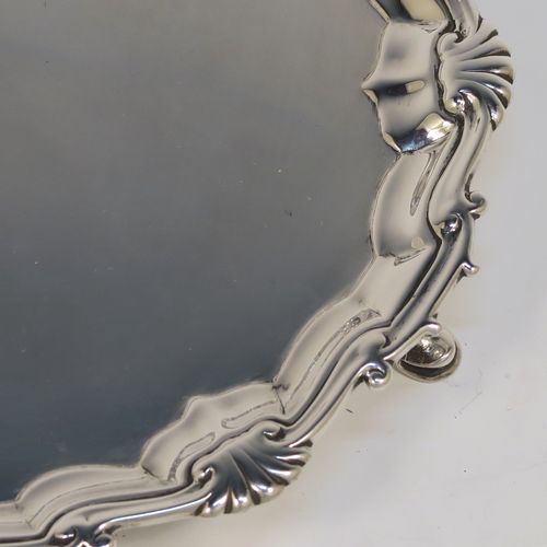 A very elegant pair of Antique Georgian Sterling Silver George II salvers, having plain grounds with applied shaped gadroon and scroll borders, and sitting on three cast hoof feet. These beautiful antique silver salvers were made by John Tuite of London in 1750. The dimensions of these fine hand-made antique Goerge II silver salvers are diameter 17 cms (6.75 inches), and they weigh approx. 475g (15.3 troy ounces).