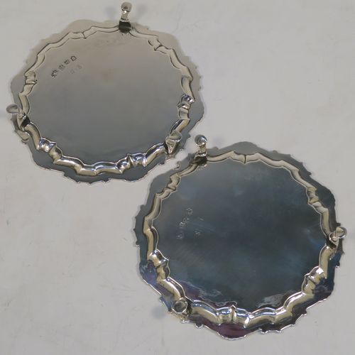 A very elegant pair of Antique Georgian Sterling Silver George II salvers, having plain grounds with applied shaped gadroon and scroll borders, and sitting on three cast hoof feet. These beautiful antique silver salvers were made by John Tuite of London in 1750. The dimensions of these fine hand-made antique Goerge II silver salvers are diameter 17 cms (6.75 inches), and they weigh approx. 475g (15.3 troy ounces).