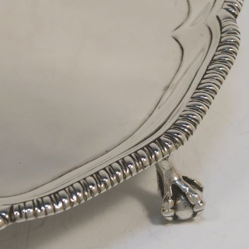 A very handsome Antique Georgian Sterling Silver salver, having an applied shaped gadroon border, a plain ground with a hand-engraved full armorial crest with a Latin inscription for Faith Is All, and sitting on three cast claw and ball feet. This elegant antique silver salver was made by John Crouch of London in 1770. The dimensions of this fine hand-made silver salver are diameter 20 cms (8 inches), and it weighs approx. 343g (11 troy ounces).