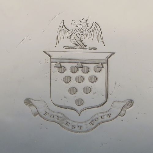 A very handsome Antique Georgian Sterling Silver salver, having an applied shaped gadroon border, a plain ground with a hand-engraved full armorial crest with a Latin inscription for Faith Is All, and sitting on three cast claw and ball feet. This elegant antique silver salver was made by John Crouch of London in 1770. The dimensions of this fine hand-made silver salver are diameter 20 cms (8 inches), and it weighs approx. 343g (11 troy ounces).