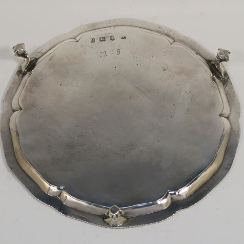 A very handsome Antique Georgian Sterling Silver salver, having an applied shaped gadroon border, a plain ground with a hand-engraved full armorial crest with a Latin inscription for Faith Is All, and sitting on three cast claw and ball feet. This elegant antique silver salver was made by John Crouch of London in 1770. The dimensions of this fine hand-made silver salver are diameter 20 cms (8 inches), and it weighs approx. 343g (11 troy ounces).