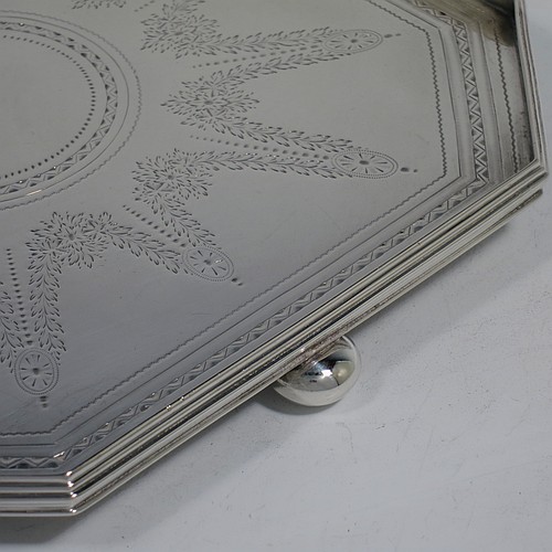 A very handsome and unusual Antique Victorian Sterling silver salver, having an octagonal body, a hand-engraved ground with floral swags and bands of bright-cut decoration, an applied reeded gallery border, and sitting on three cast cushion ball feet. Made by the Barnard Brothers of London in 1897. The dimensions of this fine hand-made antique salver are 21 cms (8.25 inches) square, height 2.5 cms (1 inch), and it weighs approx. 574g (18.5 troy ounces).