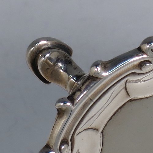 An Antique Georgian Sterling Silver salver, having a plain burnished ground, an applied shell and scroll border, and sitting on three cast hoof feet. Made by James Wilks of London in 1752. The dimensions of this fine hand-made antique silver salver are diameter 19 cms (7.55 inches), and it weighs approx. 262g (8.5 troy ounces).