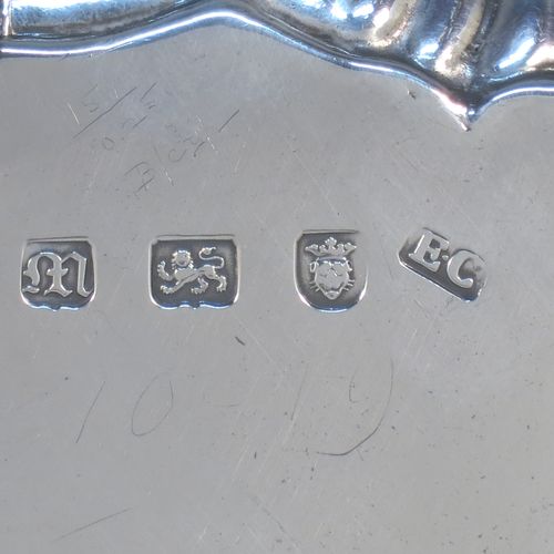 A very elegant Antique Georgian Sterling Silver salver, having a plain burnished ground, an applied shell and scroll border, and sitting on three cast hoof feet. Made by Ebenezer Coker of London in 1767. The dimensions of this fine hand-made antique silver salver are diameter 21 cms (8.5 inches), and it weighs approx. 310g (10 troy ounces).