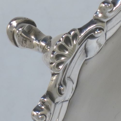 A very elegant Antique Georgian Sterling Silver salver, having a plain burnished ground, an applied shell and scroll border, and sitting on three cast hoof feet. Made by Ebenezer Coker of London in 1767. The dimensions of this fine hand-made antique silver salver are diameter 21 cms (8.5 inches), and it weighs approx. 310g (10 troy ounces).