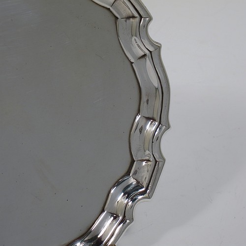 An Antique Georgian Sterling Silver George II round salver, having a plain burnished ground, an applied Chippendale border, and sitting on three cast hoof feet. Made by George Hindmarsh of London in 1736. The dimensions of this fine hand-made antique silver salver are diameter 15.5 cms (6 inches), and it weighs approx. 209g (6.7 troy ounces).