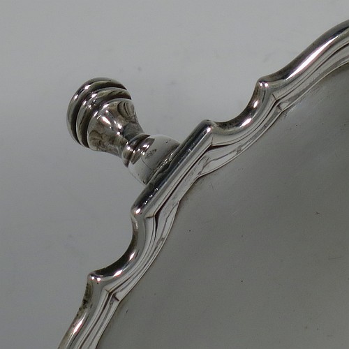 An Antique Georgian Sterling Silver George II round salver, having a plain burnished ground, an applied Chippendale border, and sitting on three cast hoof feet. Made by George Hindmarsh of London in 1736. The dimensions of this fine hand-made antique silver salver are diameter 15.5 cms (6 inches), and it weighs approx. 209g (6.7 troy ounces).