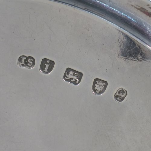 A very handsome Antique Georgian Sterling Silver pair of salvers, having applied reeded borders, plain grounds with hand-engraved central crests, and sitting on three cast reeded flange feet. Made by John Schofiled of London in 1784. The dimensions of these fine hand-made antique silver pair of salvers are diameter 19 cms (7.5 inches), and they weigh a total of approx. 682g (22 troy ounces).