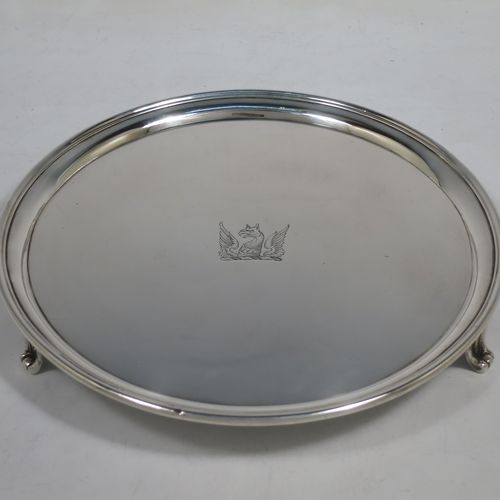 A very handsome Antique Georgian Sterling Silver pair of salvers, having applied reeded borders, plain grounds with hand-engraved central crests, and sitting on three cast reeded flange feet. Made by John Schofiled of London in 1784. The dimensions of these fine hand-made antique silver pair of salvers are diameter 19 cms (7.5 inches), and they weigh a total of approx. 682g (22 troy ounces).