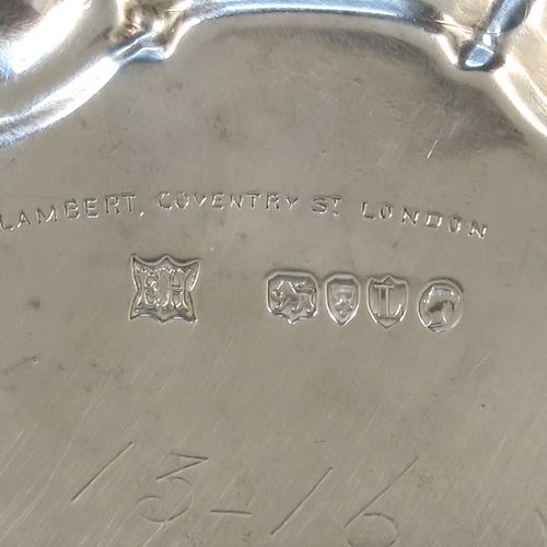 A very handsome Antique Victorian Sterling Silver round salver, having a plain burnished ground, an applied scroll border and sitting on three cast scroll feet. This beautiful antique silver salver was made by Edward Hutton of London in 1886. The dimensions of this fine hand-made antique silver salver are diameter 20 cms (8 inches), and it weighs approx. 422g (13.6 troy ounces).