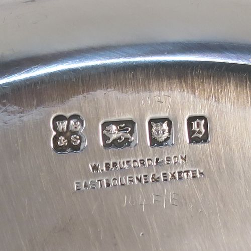 A very handsome Antique Sterling Silver salver, having a round body with a plain burnished ground, a raised border, and sitting on three cast flange feet. This elegant silver salver was made by William Bruford and Sons of London in 1922. The dimensions of this fine hand-made antique silver salver are diameter 20 cms (8 inches), height 2 cms (1 inch), and it weighs approx. 500gg (16 troy ounces).