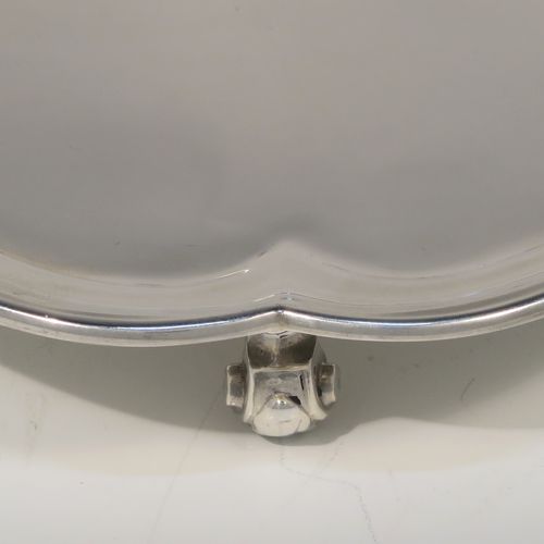 A very handsome Sterling Silver salver, having a square body with an applied cut-corner border, a plain ground, and sitting on four cast scroll feet. This elegant silver salver was made by Josiah Williams and Co., of London in 1939. The dimensions of this fine hand-made silver salver are 19 cms (7.5 inches) square, and it weighs approx. 302g (9.7 troy ounces).
