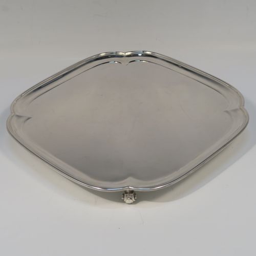 A very handsome Sterling Silver salver, having a square body with an applied cut-corner border, a plain ground, and sitting on four cast scroll feet. This elegant silver salver was made by Josiah Williams and Co., of London in 1939. The dimensions of this fine hand-made silver salver are 19 cms (7.5 inches) square, and it weighs approx. 302g (9.7 troy ounces).