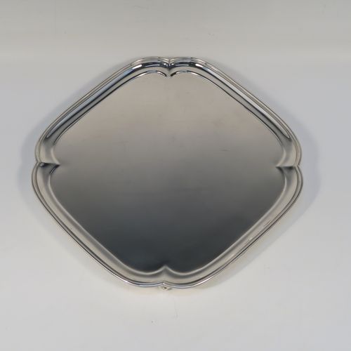 A very handsome Sterling Silver salver, having a square body with an applied cut-corner border, a plain ground, and sitting on four cast scroll feet. This elegant silver salver was made by Josiah Williams and Co., of London in 1939. The dimensions of this fine hand-made silver salver are 19 cms (7.5 inches) square, and it weighs approx. 302g (9.7 troy ounces).