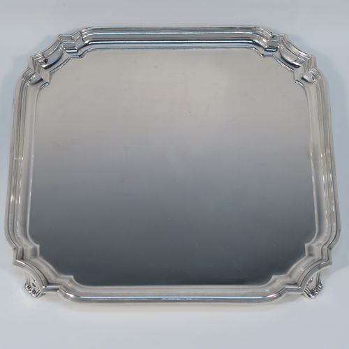 A heavy and very elegant Sterling Silver salver, having a square body with an applied cut-corner and reeded border, a plain ground, and sitting on four cast flanged feet. This handsome silver salver was made by William Hutton and Sons of Sheffield in 1937. The dimensions of this fine hand-made silver salver are 20 cms (8 inches) square, and it weighs approx. 466g (15 troy ounces).   