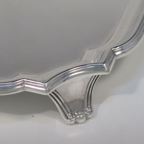A heavy and very elegant Sterling Silver salver, having a square body with an applied cut-corner and reeded border, a plain ground, and sitting on four cast flanged feet. This handsome silver salver was made by William Hutton and Sons of Sheffield in 1937. The dimensions of this fine hand-made silver salver are 20 cms (8 inches) square, and it weighs approx. 466g (15 troy ounces).