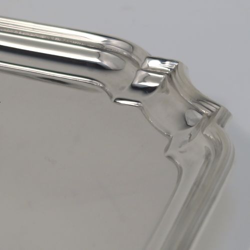 A heavy and very elegant Sterling Silver salver, having a square body with an applied cut-corner and reeded border, a plain ground, and sitting on four cast flanged feet. This handsome silver salver was made by William Hutton and Sons of Sheffield in 1937. The dimensions of this fine hand-made silver salver are 20 cms (8 inches) square, and it weighs approx. 466g (15 troy ounces).