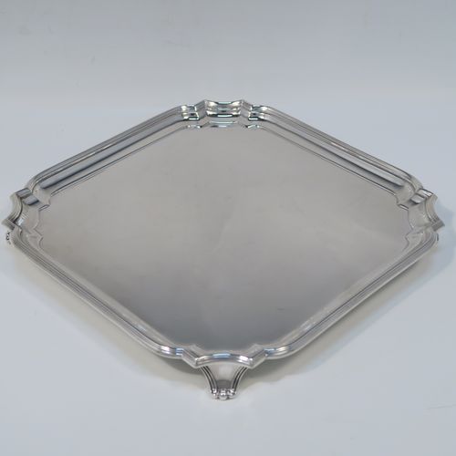 A heavy and very elegant Sterling Silver salver, having a square body with an applied cut-corner and reeded border, a plain ground, and sitting on four cast flanged feet. This handsome silver salver was made by William Hutton and Sons of Sheffield in 1937. The dimensions of this fine hand-made silver salver are 20 cms (8 inches) square, and it weighs approx. 466g (15 troy ounces).