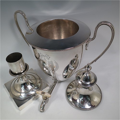 A very handsome Antique Georgian Neoclassical style Sterling Silver samovar, having a plain urn-shaped body, with pull-off lid and finial, two side-handles, an original spigot with bone handle, all with applied bead-edged borders, and all sitting on a pedestal foot with a square base. Please note that this piece has an unusual heating mechanism where the main body detaches from the foot allowing for the insertion of a heated piece of pig-iron. Made by John Denziloe of London in 1783. The dimensions of this fine hand-made antique silver samovar are height 52 cms (20.5 inches), width 33 cms (13 inches), and it weighs approx. 3,112g (100 troy ounces). Please note that this item is crested.