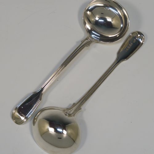 A beautiful Antique Victorian Sterling Silver pair of sauce ladles in the double-struck Fiddle and Thread pattern, having oval bowls. These elegant silver sauce ladles were made by the most important Victorian cutlery maker, George Adams, of London in 1845. The dimensions of this fine pair of hand-made antique silver sauce ladles are length 18.5 cms (7.25 inches), and they weigh a total of approx. 148g (4.8 troy ounces).