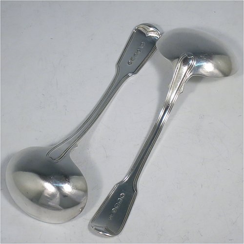 An Antique Georgian Sterling Silver pair of Sauce Ladles in the double-struck Fiddle & Thread pattern. Made by George Piercy of London in 1821. The dimensions of this fine pair of hand-made antique silver sauce ladles are length 17 cms (6.75 inches), and they weigh a total of approx. 140g (4.5 troy ounces). Please note that these items are crested.