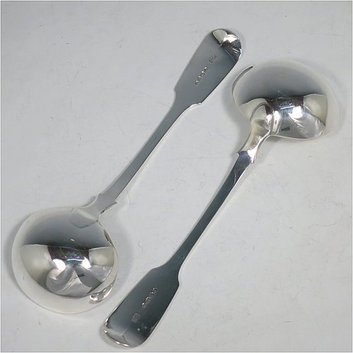 An Antique Victorian Sterling Silver pair of Sauce Ladles in the plain Fiddle pattern with pip on reverse. Made by Charles Lias of London in 1847. The dimensions of this fine pair of hand-made antique silver sauce ladles are length 18.5 cms (7.25 inches), and they weigh a total of approx. 140g (4.5 troy ounces).