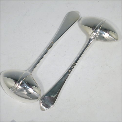 A Sterling Silver pair of Sauce Ladles in the plain Dog-nose pattern with Rattail on reverse, and oval bowls. Made by Goldsmiths & Silversmiths of London in 1917. The dimensions of this fine pair of hand-made silver sauce ladles are length 18 cms (7 inches), and they weigh a total of approx. 155g (5 troy ounces).