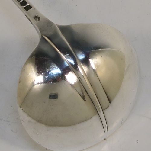 An unusual pair of long-handled Sterling Silver sauce or cream Ladles in the Rattail Hanoverian pattern, having plain round bowls, and long plain handles. This elegant pair of silver ladles were made by Robert Comyns of London in 1975. The dimensions of this fine pair of hand-made silver cream or sauce ladles are length 18 cms (7 inches), and they weigh a total of approx. 98g (3.2 troy ounces).