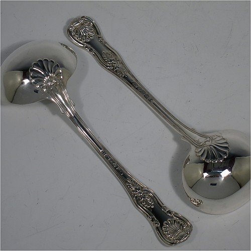 An Antique Georgian Sterling Silver pair of Sauce Ladles in the double-struck Kings pattern. Made by Charles Eley of London in 1825. The dimensions of this fine pair of hand-made Kings Pattern antique silver sauce ladles are length 17 cms (6.75 inches), and they weigh a total of approx. 147g (4.7 troy ounces).