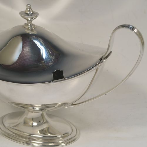 A very elegant Sterling Silver pair of sauce tureens with covers, having plain oval neoclassical boat-shaped bodies with applied reeded borders, pull-off lids with cast finials, with reeded loop side-handles, and all sitting on pedestal feet. These beautiful silver sauce tureens were made by Thomas Bradbury of Sheffield in 1931. The dimensions of this fine hand-made silver2 pair of sauce tureens are height 13.5 cms (5.5 inches), length 23 cms (9 inches), width 10 cms (4 inches), with a total weight of approx. 853g (27.5 troy ounces).