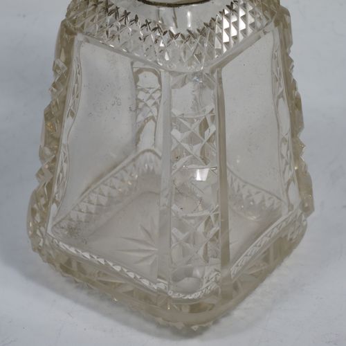 A very pretty and unusual pair of Antique Victorian Sterling Silver and hand-cut crystal table scent bottle, having plain round mounts  with hinged lids, gold-gilt interiors and internal stoppers. The crystal bodies with square cross-sections and tapering sides having clear side panels and hobnail cut edges, and all sitting on star-cut bases. Made by John Grinsell and Co., of London in 1898. The dimensions of these fine hand-made antique silver and crystal scent bottles are height 14.5 cms (5.75 inches), and 7cms (2.75 inches) square at base.    