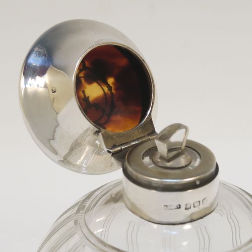 A very pretty Sterling Silver and inlaid tortoise-shell hand-cut crystal table scent bottle, having a plain round mount, a hinged lid with an inlaid tortoise-shell cover, an internal stopper, and hand-cut main body with reeding and star-cut decoration. This beautiful silver and crystal scent bottle was made by Hasset and Harper Ltd., of Birmingham in 1921. The dimensions of this fine hand-made silver and tortoise shell scent bottle are height 10 cms (4 inches), and diameter 9 cms (3.5 inches).