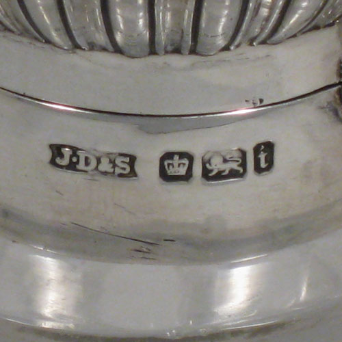 Antique Victorian sterling silver and hand-cut crystal large table scent bottle, having a hand-chased round mount with swirl-flute decoration, a hinged lid, an internal stopper, and hobnail cut main body with a shield-shaped cartouche. Made by James Dixon and Sons of Sheffield in 1901. The dimensions of this fine hand-made scent bottle are height 15 cms (6 inches), and diameter 11 cms (4.25 inches).   