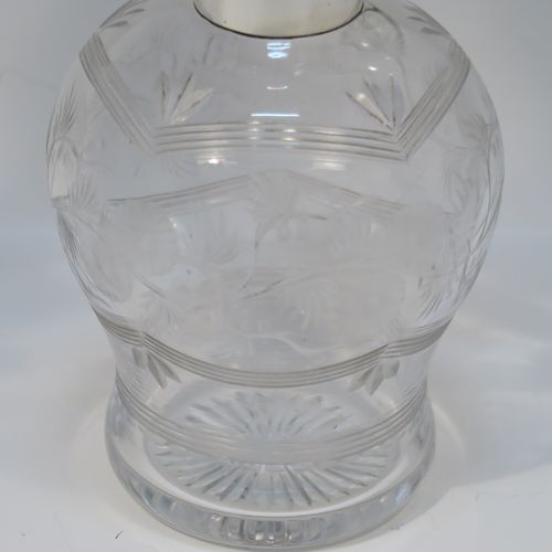A very beautiful Sterling Silver and inlaid tortoise-shell hand-cut crystal table scent bottle, having a plain round mount, a hinged lid with an inlaid tortoise-shell cover, an internal stopper, a round main body with frosted cut floral hand-engraving and bands of reeded decoration, and siting on a flat base with hand-engraved star-cut work. This pretty silver and crystal scent bottle was made by Henry Matthew of Birmingham in 1928. The dimensions of this fine hand-made silver and tortoise shell scent bottle are height 14 cms (5.5 inches), and diameter 8.5 cms (3.3 inches).