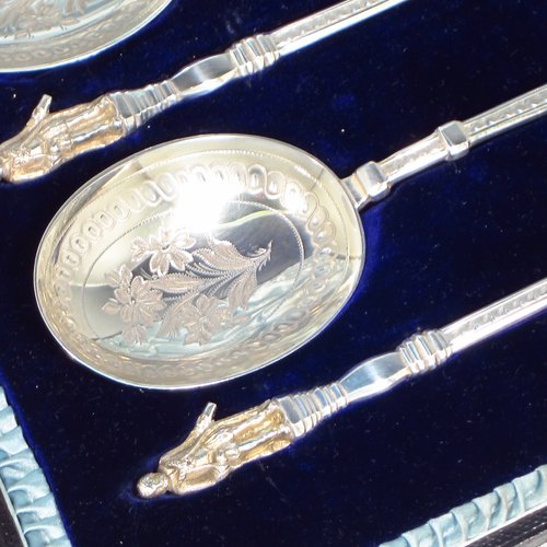 An Antique Victorian Sterling silver set of four serving spoons, having cast handles with figural terminals, and hand-engraved oval bowls with floral decoration, and sitting in a satin and blue velvet-lined presentation box. Made by Walker & Hall of Sheffield in 1892. The dimensions of this fine hand-made set of four silver serving spoons are length 22cms (8.6 inches), and they weigh a total of approx. 333g (10.7 troy ounces).
