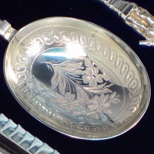 An Antique Victorian Sterling silver set of four serving spoons, having cast handles with figural terminals, and hand-engraved oval bowls with floral decoration, and sitting in a satin and blue velvet-lined presentation box. Made by Walker & Hall of Sheffield in 1892. The dimensions of this fine hand-made set of four silver serving spoons are length 22cms (8.6 inches), and they weigh a total of approx. 333g (10.7 troy ounces).