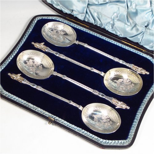 An Antique Victorian Sterling silver set of four serving spoons, having cast handles with figural terminals, and hand-engraved oval bowls with floral decoration, and sitting in a satin and blue velvet-lined presentation box. Made by Walker & Hall of Sheffield in 1892. The dimensions of this fine hand-made set of four silver serving spoons are length 22cms (8.6 inches), and they weigh a total of approx. 333g (10.7 troy ounces).