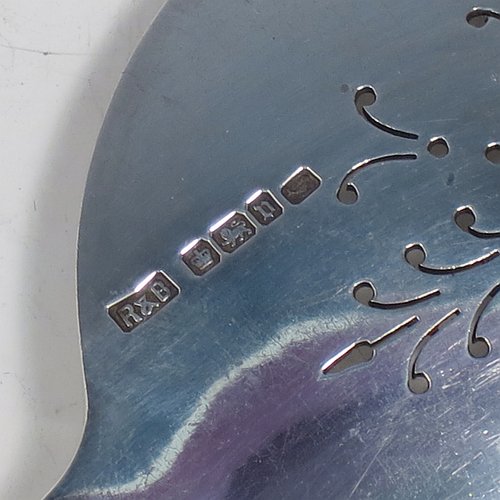 An Antique Sterling Silver serving spoon and fork, having hand-chased neoclassical pattern handles, the spoon with a hand-pierced blade, and the fork with five hand-cut tines, and all sitting in their original cream satin and dark blue velvet-lined presentation box. Made by Roberts & Belk of Sheffield in 1913. The dimensions of this fine hand-made antique pair of serving spoon and fork are length 24cms (9.5 inches), and they weigh a total of approx. 222g (7.2 troy ounces).